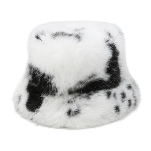 Detail of plush faux fur fisherman hat featuring black and white cow print texture