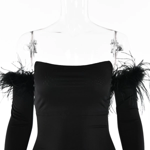 Close-up of black bodycon mini dress with elegant feather trim on shoulders and sleeves