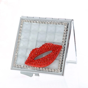 Square silver folding pocket mirror with red rhinestone lip design and crystal border