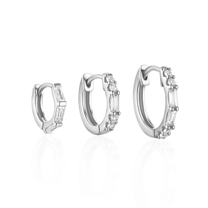 Detailed view of three silver S925 earrings with cubic zirconia in various sizes
