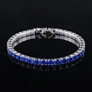 Macro detail of square cut blue sapphire tennis bracelet with silver prong setting