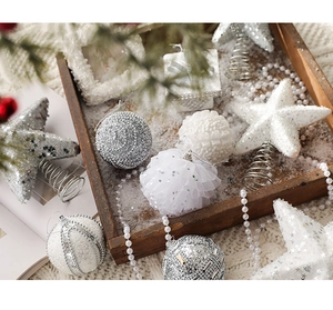 Detail showing white and silver foam Christmas balls and glittery star tree topper set