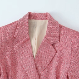 Detail of red and white chevron blazer showing classic collar and woven fabric texture