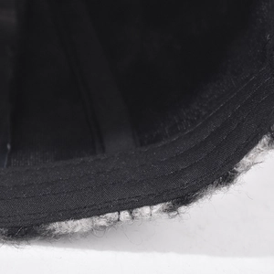 Close-up of the plush lamb wool texture and neat stitching on the checkered baseball cap