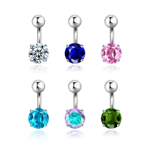 Macro detail of six stainless steel belly rings with colorful round zircon crystals