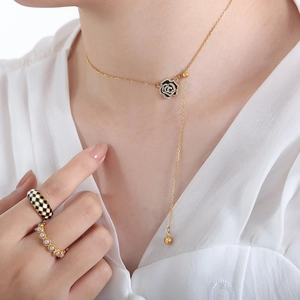 Elegant gold necklace with black enamel rose pendant and cubic zirconia details