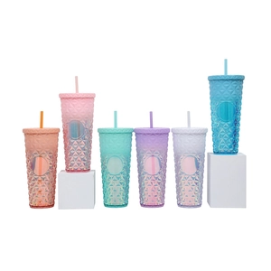 Collection of colorful studded plastic tumblers with straws and gradient diamond textures