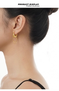 Close-up of gold S925 sterling silver tassel earrings with irregular lava texture