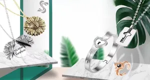 Detailed collection of sunflower necklace, heart bracelet, and crown ring on marble background