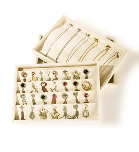 Detailed close-up of beige velvet jewelry organizer tray for necklaces and earrings