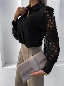 Detailed close-up of geometric lace patchwork on a black long sleeve chiffon shirt