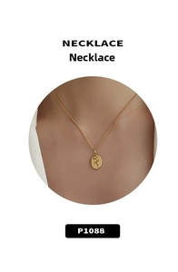 Detailed macro view of 18k gold vintage necklace with rose flower engraved oval pendant