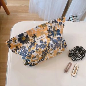 Detail shot of vintage floral cotton makeup bag with zip closure and simple wish label