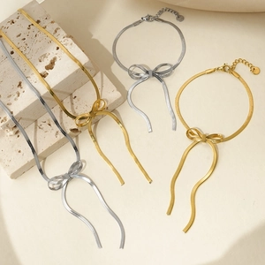 Gold and silver bow snake chain jewelry set including necklaces and bracelets