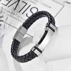 Macro shot of men's black braided leather bracelet with brushed stainless steel clasp