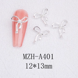 Detailed view of silver alloy bowknot nail art charm with faux pearl inlay and 12x13mm size
