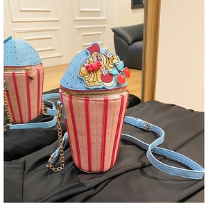 Detail of dessert-shaped crossbody bag with pink and blue panels and gold chain strap