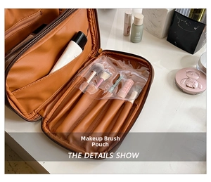 Detail of caramel leather makeup bag showing brush slots and transparent PVC cover