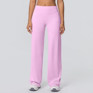Detail of high-waisted flared yoga pants in soft pink brushed fabric for fitness
