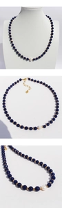 Detail of lapis lazuli beaded necklace with a baroque pearl and adjustable gold chain