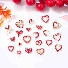 Detailed view of red rhinestone heart nail charms with gold metal bases and 520 engraving