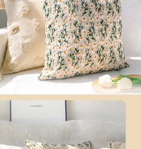 Detailed embroidery of daisies and 3D polka dots on beige throw pillow covers