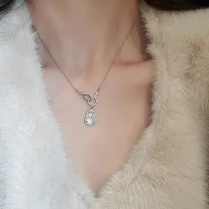 Chic gourd necklace with white chalcedony and zircons worn on a cozy faux fur coat