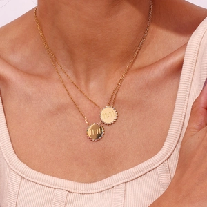 Double-layered gold titanium necklace with sunflower 11:11 pendants worn by a model