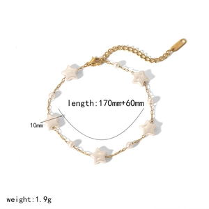 Gold stainless steel bracelet with star beads and white pearls on white background