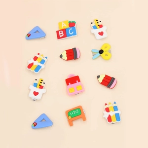 Detailed view of 12 cartoon stationery hair clips featuring colorful pencils and rulers