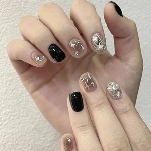 Handmade black press-on nails with sparkling star pattern and silver rhinestones