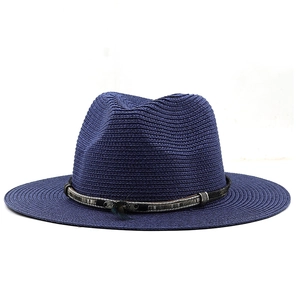 Detail of dark blue straw fedora with metallic feather band on white background