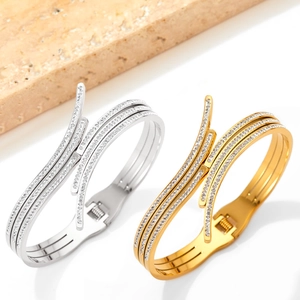 Stack of gold and silver stainless steel open bracelets with paved cubic zirconia stones