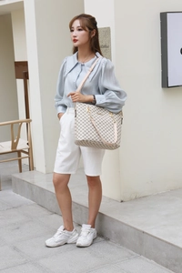 Detailed view of beige geometric pattern tote bag with pink strap for casual women's fashion