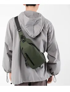 Men's dark green sling bag shown on model with adjustable strap and waterproof fabric
