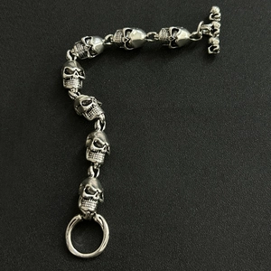 Detailed view of hip hop skeleton link bracelet with vintage silver finish and T-bar clasp