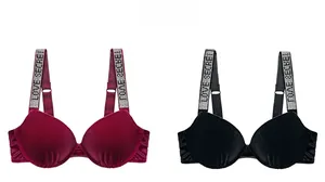 Detailed view of burgundy and black velvet push-up bras with rhinestone letter straps