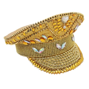 Detail of gold captain hat with sequins, crystals and a central heart pearl pendant