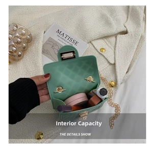 Detail showing the internal capacity of the mint green silicone quilted handbag with items