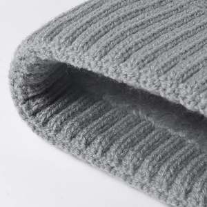 Close-up of thick grey ribbed knit beanie for women with warm thermal winter texture
