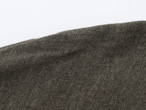 Macro view of olive green and brown textured tweed fabric with thick fiber weave