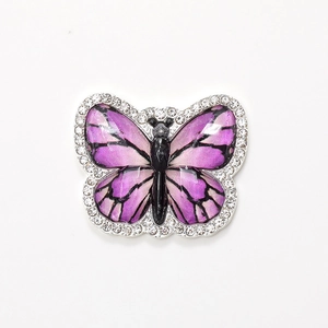 Purple crystal butterfly brooch accessory with white rhinestones and silver metal frame