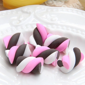 Macro shot of pink and brown spiral marshmallow clay charms for DIY phone case decor