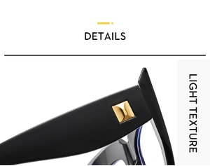 Close-up of black chunky eyeglass frames with gold square metal accents and light texture
