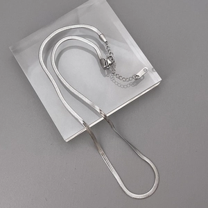Close-up of double-layered silver snake chain necklace with lobster clasp and extender