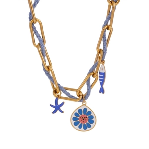 Detailed close-up of golden chain and blue braided rope with colorful charms