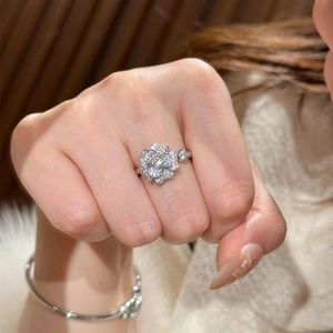 Macro shot of camellia flower open ring with sparkling pavé zircons and metal finish