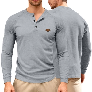 Close-up of grey waffle knit henley shirt with three-button neckline and leather patch