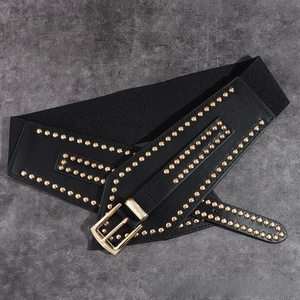 Detail of black elastic corset belt featuring gold rivet studs and metal buckle closure