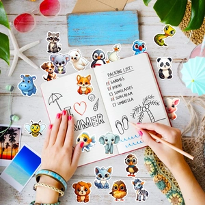 Detail of cute animal stickers with raccoon and panda on a beach themed desk setup